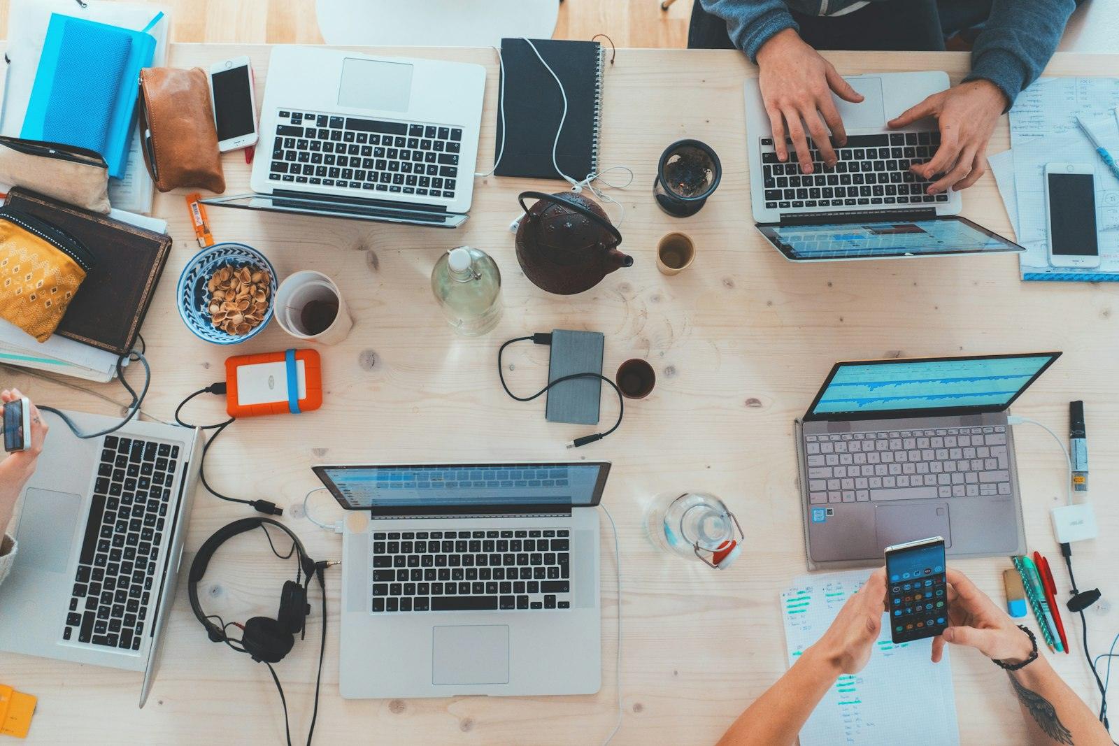 Laptops and notebooks on a shared desk