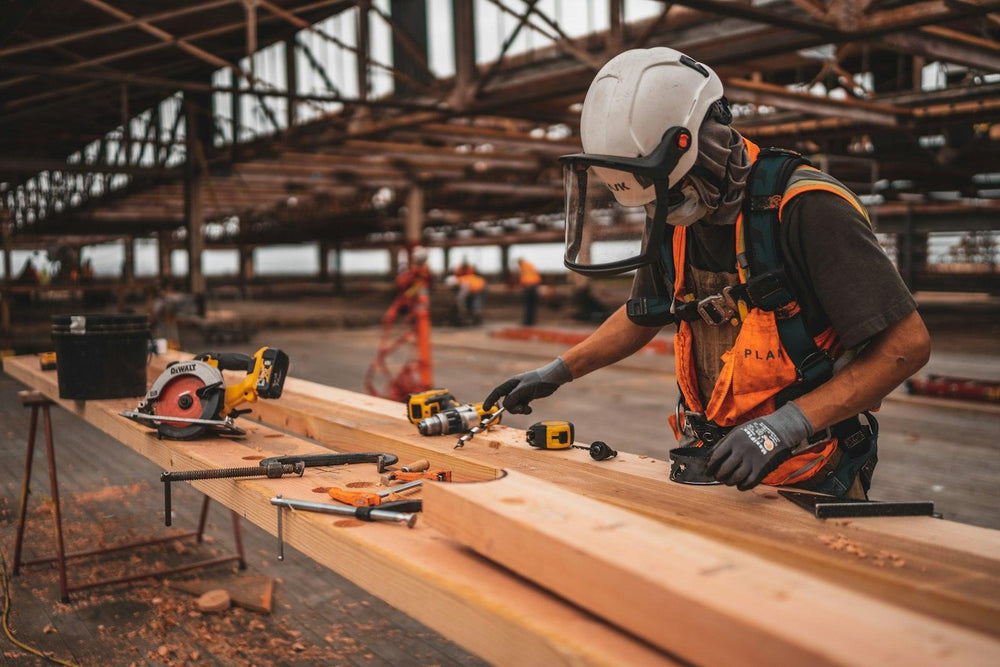 Carpenter measuring timber for a building job in Cranfield